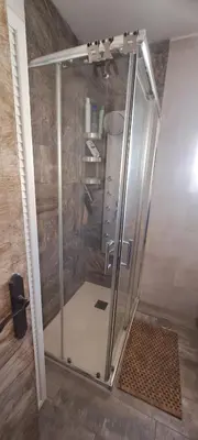 a shower with a glass door in a bathroom at Playas, cultura y gastronomía en Casa Sarco 2 habitaciones in San Fernando
