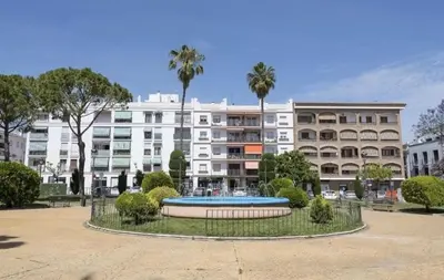 a large apartment building with a fountain in a park at En el mismo Centro - Aires del Puerto in El Puerto de Santa María