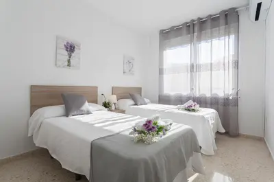 a bedroom with two beds with flowers on them at Luminoso 3 rooms 2 Baños Parking in Jerez de la Frontera