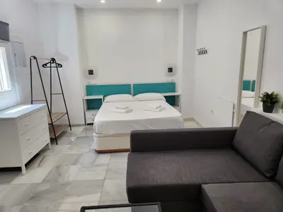 a living room with a bed and a couch at Allo Apartments 