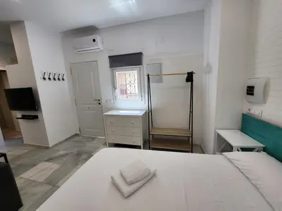 a bedroom with a white bed with two towels on it at Allo Apartments 