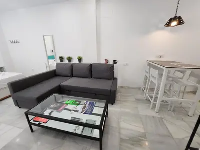 a living room with a couch and a table at Allo Apartments 