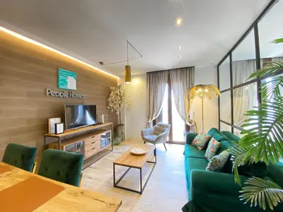 a living room with a blue couch and a tv at People Homes Ponce 13 in Jerez de la Frontera