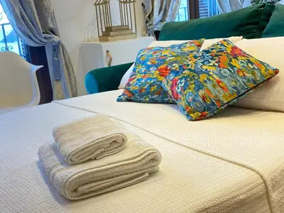 a bed with two towels on it with a pillow at People Homes Ponce 13 in Jerez de la Frontera