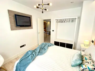 a bedroom with a bed and a tv on the wall at People Homes Ponce 13 in Jerez de la Frontera