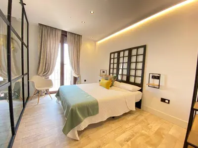a bedroom with a large bed with yellow pillows at People Homes Ponce 13 in Jerez de la Frontera