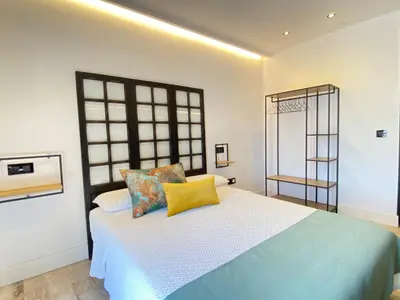 a bedroom with a bed with yellow pillows at People Homes Ponce 13 in Jerez de la Frontera