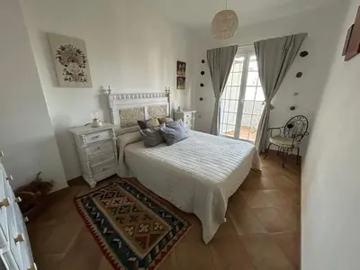 a bedroom with a bed with a white bedspread at Apartamento residencial de golf y playa Cadiz in Rota
