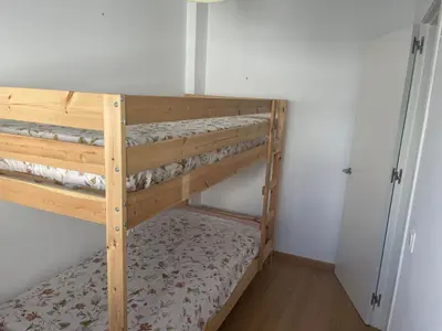 a couple of bunk beds in a room at Piso coqueto Chiclana in Chiclana de la Frontera