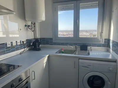 a kitchen with a sink and a washing machine at Piso coqueto Chiclana in Chiclana de la Frontera