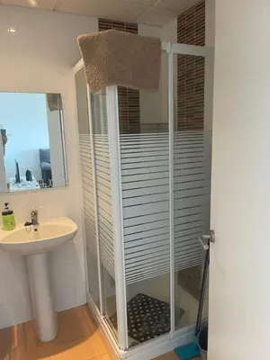 a shower in a bathroom with a sink at Piso coqueto Chiclana in Chiclana de la Frontera