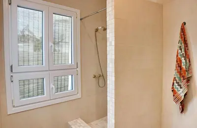 a bathroom with a shower and a window at Casa Aqua in El Guijo