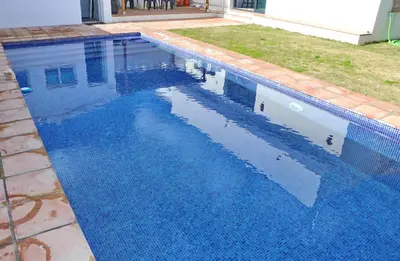 a swimming pool with blue water in a yard at Casa Aqua in El Guijo