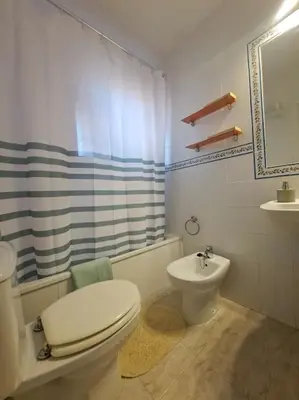 a bathroom with a toilet and a sink at Novo Sancti Petri, con piscina todo el año, La Mariposa by Chiclana Dreams in Chiclana de la Frontera
