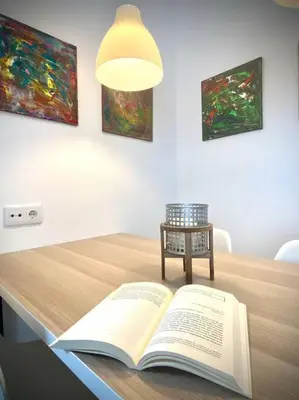 an open book sitting on a table with a lamp at MyChoice Ático de Luna in Rota