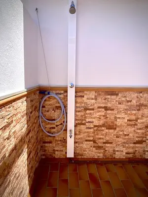 a room with a brick wall and a hose at MyChoice Ático de Luna in Rota