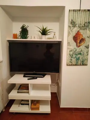 a large flat screen tv on a white entertainment center at Apartamento Las Canastas Cádiz Centro a pie de Catedral y playa in Cádiz