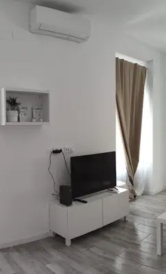 a living room with a couch and a table and chairs at Apartamento Cerrofuerte in Jerez de la Frontera