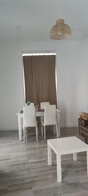 a dining room with white tables and white chairs at Apartamento Cerrofuerte in Jerez de la Frontera