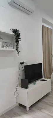 a white living room with a flat screen tv at Apartamento Cerrofuerte in Jerez de la Frontera