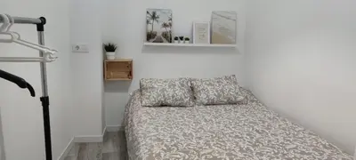 a white table with a mirror and some pictures at Apartamento Cerrofuerte in Jerez de la Frontera