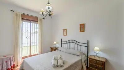 a bedroom with a bed with two pairs of shoes on it at Villanueva - Casa 2 Conil Frontera by Ruralidays in Conil de la Frontera