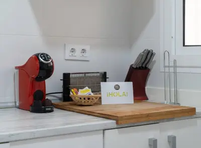 a kitchen counter with a cutting board with a holaiba box at Apartoyou - Centro Histórico in El Puerto de Santa María