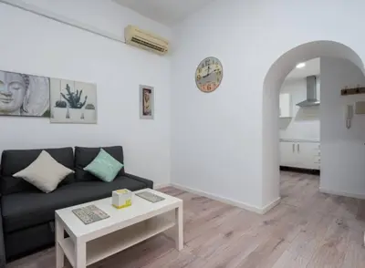 a living room with a couch and a table at Apartoyou - Centro Histórico in El Puerto de Santa María