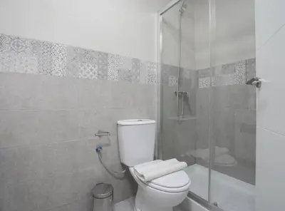 a bathroom with a toilet and a glass shower at Apartoyou - Centro Histórico in El Puerto de Santa María