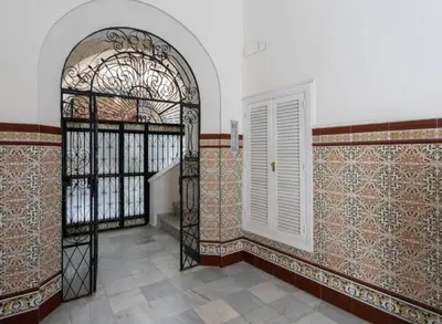 a room with an arch and a door and a staircase at Apartoyou - Centro Histórico in El Puerto de Santa María