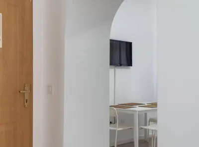 a room with a white table and chairs and a window at Apartoyou - Centro Histórico in El Puerto de Santa María