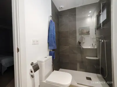 a bathroom with a toilet and a glass shower at Rota Punta Candor Terrace Playa 3 Bajo C in Rota