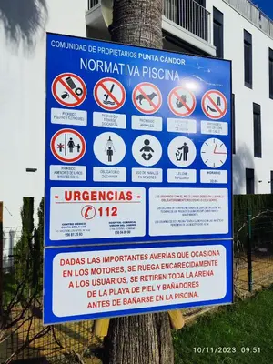 a sign on a tree with many signs on it at Rota Punta Candor Terrace Playa 3 Bajo C in Rota