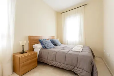 a bedroom with a large bed and a window at Apartamento Playa Cádiz by ISA Hoteles in Cádiz