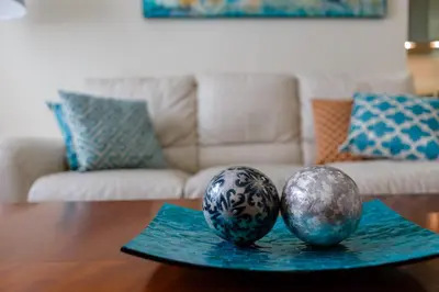 two balls sitting on a table in a living room at Apartamento Playa Cádiz by ISA Hoteles in Cádiz