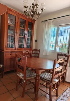 a dining room with a wooden table and chairs at Relaxing Sanlúcar in Sanlúcar de Barrameda