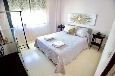 a bedroom with a bed with towels on it at El rinconcito de la Isla in San Fernando