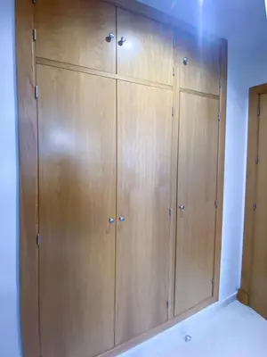 a large closet with wooden cabinets in a room at El rinconcito de la Isla in San Fernando