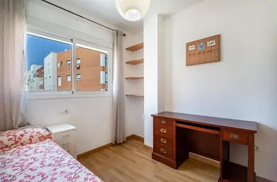 a bedroom with a bed and a desk and a window at Sensacional piso en San Fernando in San Fernando