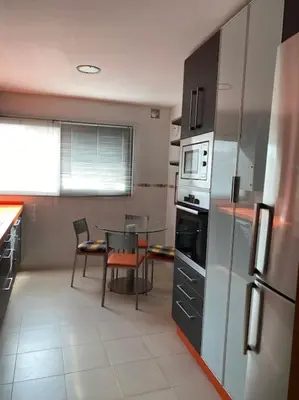 a kitchen with a table and a dining room at Sensacional piso en San Fernando in San Fernando