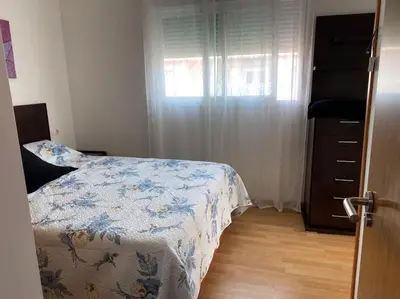 a bedroom with a bed and a dresser and a window at Sensacional piso en San Fernando in San Fernando