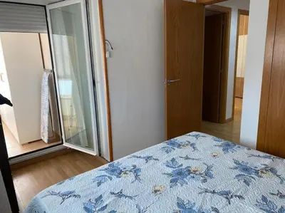 a bedroom with a bed and a large window at Sensacional piso en San Fernando in San Fernando