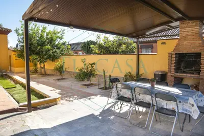 a patio with a table and chairs under a canopy at Villa Zahara de 3 habitaciones con Piscina in Cádiz