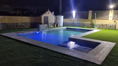 a swimming pool in a yard at night at Villa Zahara de 3 habitaciones con Piscina in Cádiz
