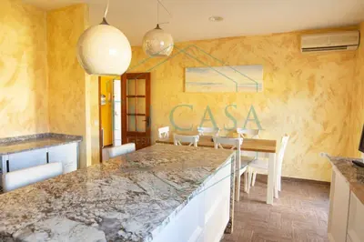 a kitchen with a table and a dining room at Villa Zahara de 3 habitaciones con Piscina in Cádiz