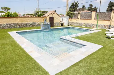a swimming pool in a yard with grass at Villa Zahara de 3 habitaciones con Piscina in Cádiz
