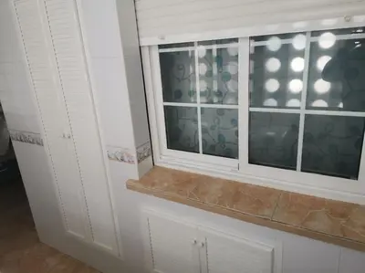 a window in a kitchen with white cabinets at Piso en la Costilla-Rota in Rota