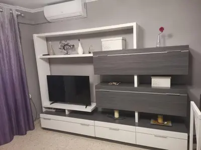a living room with a entertainment center with a television at Piso en la Costilla-Rota in Rota