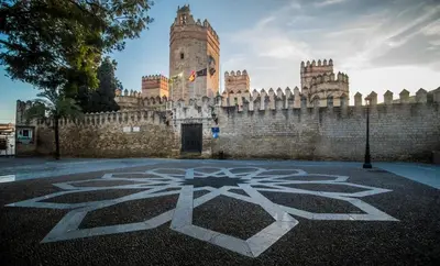 a large castle with a clock tower in front of it at Apartamento en CENTRO CIUDAD in El Puerto de Santa María