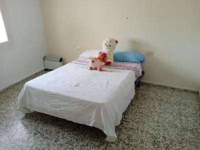 two teddy bears sitting on top of a bed at Casa luis puerto in El Puerto de Santa María